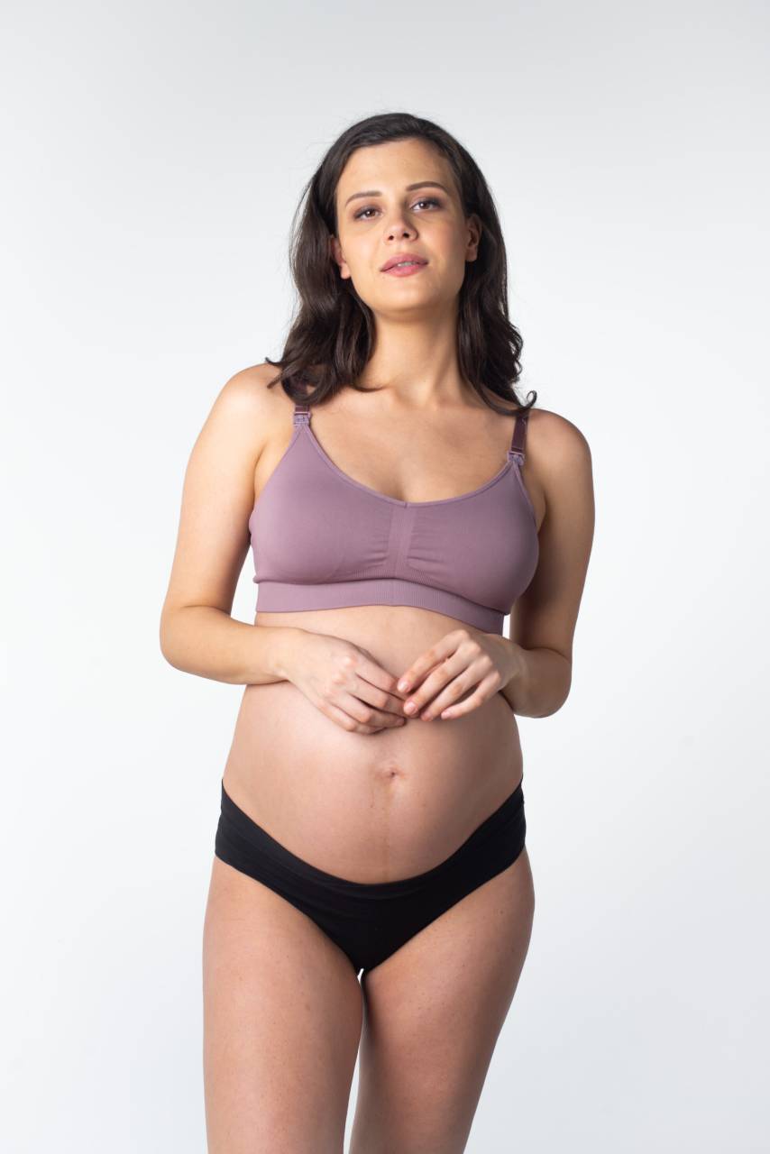 Ženski grudnjak Hotmilk My Necessity REGULAR CAP dojenje ljubičasta (MNT-regular) S.
Hotmilk grudnjak za dojilje idealan je izbor za sve trudnice i mlade majke koje traže maksimalnu udobnost i potporu za svakodnevno nošenje.
Kvalitetan materijal za vašu maksimalnu udobnost
Grudnjak Hotmilk izrađen je od fine mješavine poliamida i elastina koji osigurava prozračnost, ugodan osjećaj na tijelu i dovoljnu elastičnost.
Minimalistički dizajn i praktični detalji
Hotmilk grudnjak za dojilje je jednostavnog, glatkog kroja bez nepotrebnih šavova, koji pristaje uz svaku odjeću, grudnjak je gotovo nevidljiv ispod odjeće.
Ovaj Hotmilk grudnjak idealan je za veličine grudi A-DDD.
Zašto Hotmilk grudnjak za dojenje vrijedi isprobati

Adaptivni rez: Grudnjak se prilagođava na dvije do tri veličine košarica, osiguravajući udobnost i fleksibilnost tijekom trudnoće i nakon poroda.


Jednostavno dojenje: Praktične kopče za otvaranje jednom rukom osiguravaju lak pristup dojkama, idealne za dojenje kod kuće ili vani.


Besprijekoran dizajn: Glatka završna obrada bez šavova osigurava da grudnjak neće biti vidljiv ispod odjeće, što ga čini prikladnim za svakodnevno nošenje.


Udobnost na svakom koraku: Izvrstan izbor za bolnicu, spavanje ili mirne dane kod kuće zahvaljujući mekom i rastezljivom materijalu bez kostiju.

Hotmilk donje rublje podržat će vaše samopouzdanje tijekom trudnoće i dojenja
Razdoblje trudnoće i ranog majčinstva spada u razdoblja u životu žene kada se tijelo mijenja doslovno iz sata u sat.
Grudnjaci, gaćice ili kamisole već na prvi pogled svojim izgledom odskaču od uobičajenog asortimana donjeg rublja za trudnice i dojilje jer naglašavaju ne samo praktičnu stranu stvari, već prije svega da ženama dobro stoje.
Hotmilk njega grudnjaka
Kako bi vaš novi omiljeni grudnjak dugo trajao u savršenom stanju, preporučamo da se pridržavate sljedećih savjeta.

Pranje: Preporučujemo pranje grudnjaka na nježnom ciklusu u hladnoj vodi i korištenje zaštitne vrećice za rublje.


Sušenje: Ne preporučamo sušenje u sušilici kako bi se očuvala elastičnost i oblik grudnjaka.

Savjet: Da biste mogli uživati ​​u ovom grudnjaku zaista dugo, zaslužuje izuzetan tretman.