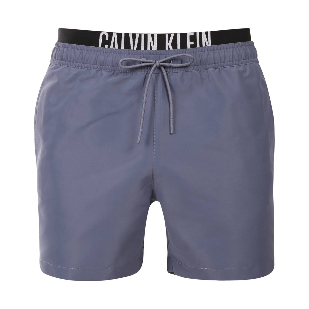 Bañador de hombre Calvin Klein gris (KM0KM01093-PCP) L.
Presentamos los bañadores para hombre de Calvin Klein que combinan el diseño icónico de la marca con elementos modernos.
Calidad Calvin Klein que no te defraudará
Los bañadores Calvin Klein están confeccionados con poliéster 100% reciclado, lo que garantiza una calidad superior al tiempo que fomenta la sostenibilidad.
Diseño pensado para su comodidad
Los bañadores Calvin Klein están diseñados pensando en la comodidad y el estilo.
¿Por qué no debería faltar en tu armario la ropa de baño Calvin Klein?

Sostenibilidad: Los bañadores se fabrican con materiales reciclados, lo que reduce el impacto en el medio ambiente.
Tecnología de secado rápido: Su moderno material le garantizará la máxima comodidad durante todo el día.
Diseño elegante y moderno: Calvin Klein nunca pasa de moda.
La elección perfecta: Serás una estrella no sólo en la playa, sino también en las fiestas en la piscina o en cualquier deporte acuático.

La ropa interior Calvin Klein te da un estilo único
La ropa interior masculina Calvin Klein es uno de los incondicionales de la industria de la moda.
Cómo cuidar los bañadores Calvin Klein
Para que los bañadores Calvin Klein mantengan su calidad y color durante mucho tiempo, es importante seguir el procedimiento de mantenimiento correcto.

Lavandería: Lávalos en la lavadora a 30 °C como máximo y utiliza un detergente suave que no dañe el material.
Secado: No seques el bañador en la secadora, mejor déjalo secar al aire libre a la sombra para evitar que el color rojo vivo se destiña.
Almacenamiento: Una vez completamente seco, guarda el bañador en un lugar seco y bien ventilado para evitar la formación de moho.

Consejo: Encontrar la prenda interior adecuada que se adapte perfectamente a ti puede ser todo un reto.